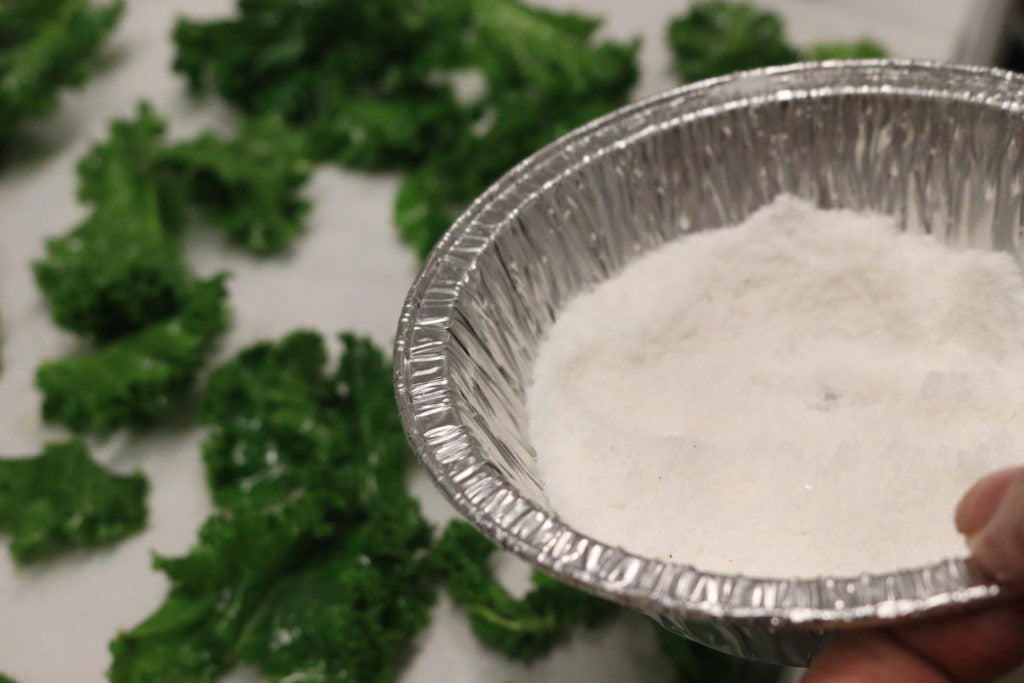 spread kale evenly on baking sheet