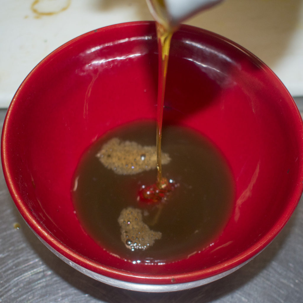 In a small bowl stir together the coconut aminos, honey and coconut vinegar