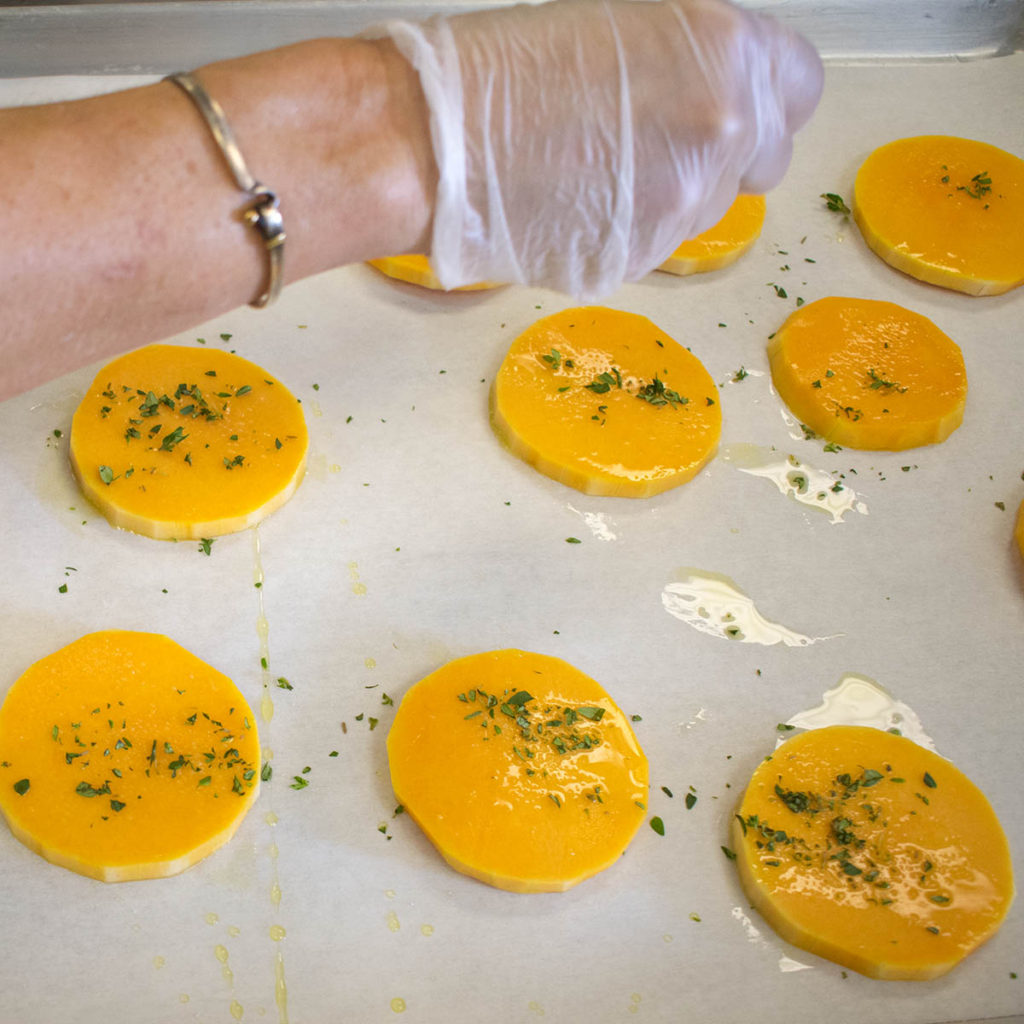 Sprinkle chopped thyme on butternut squash disks