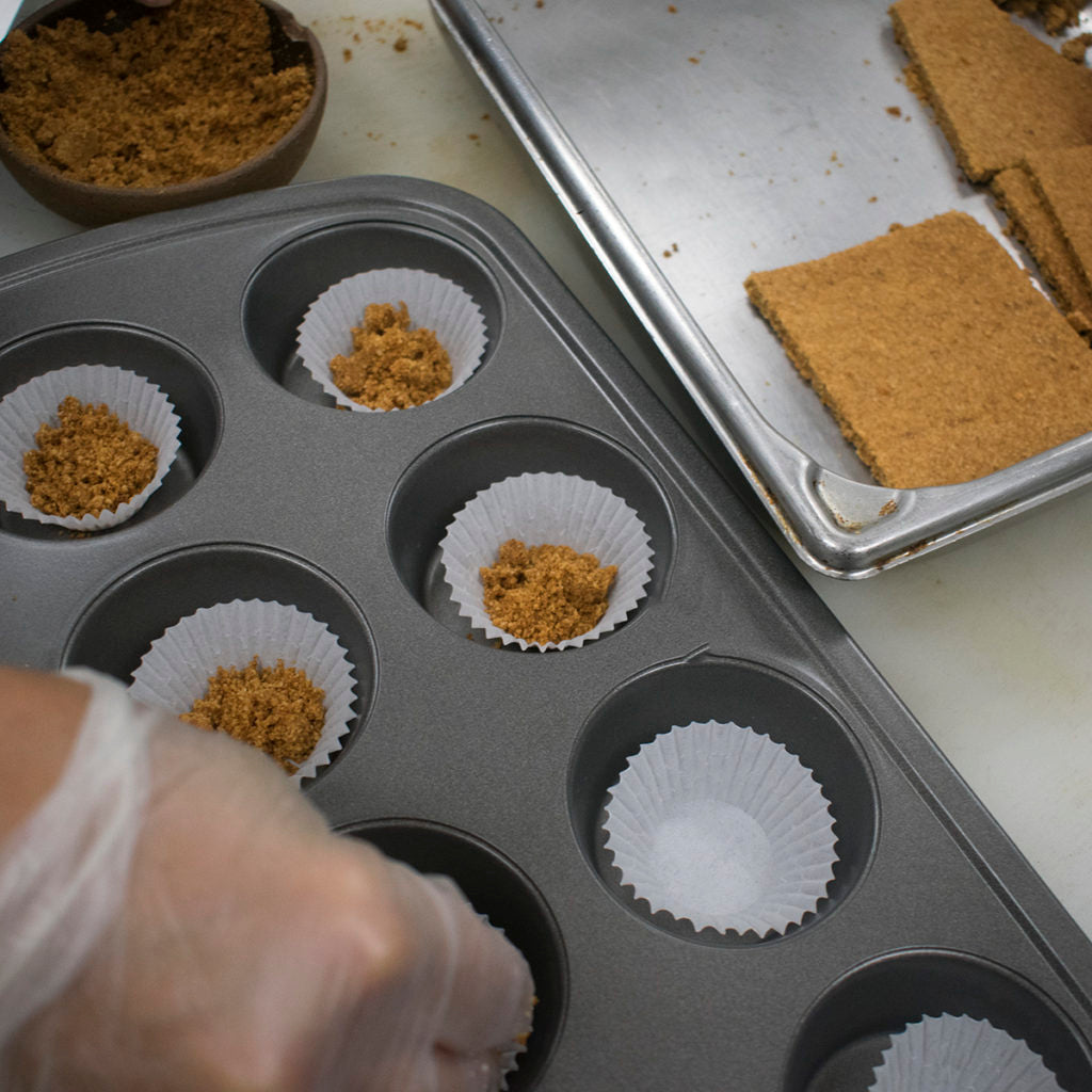 Sprinkle a few teaspoons of crumbs into the bottom of each cupcake paper