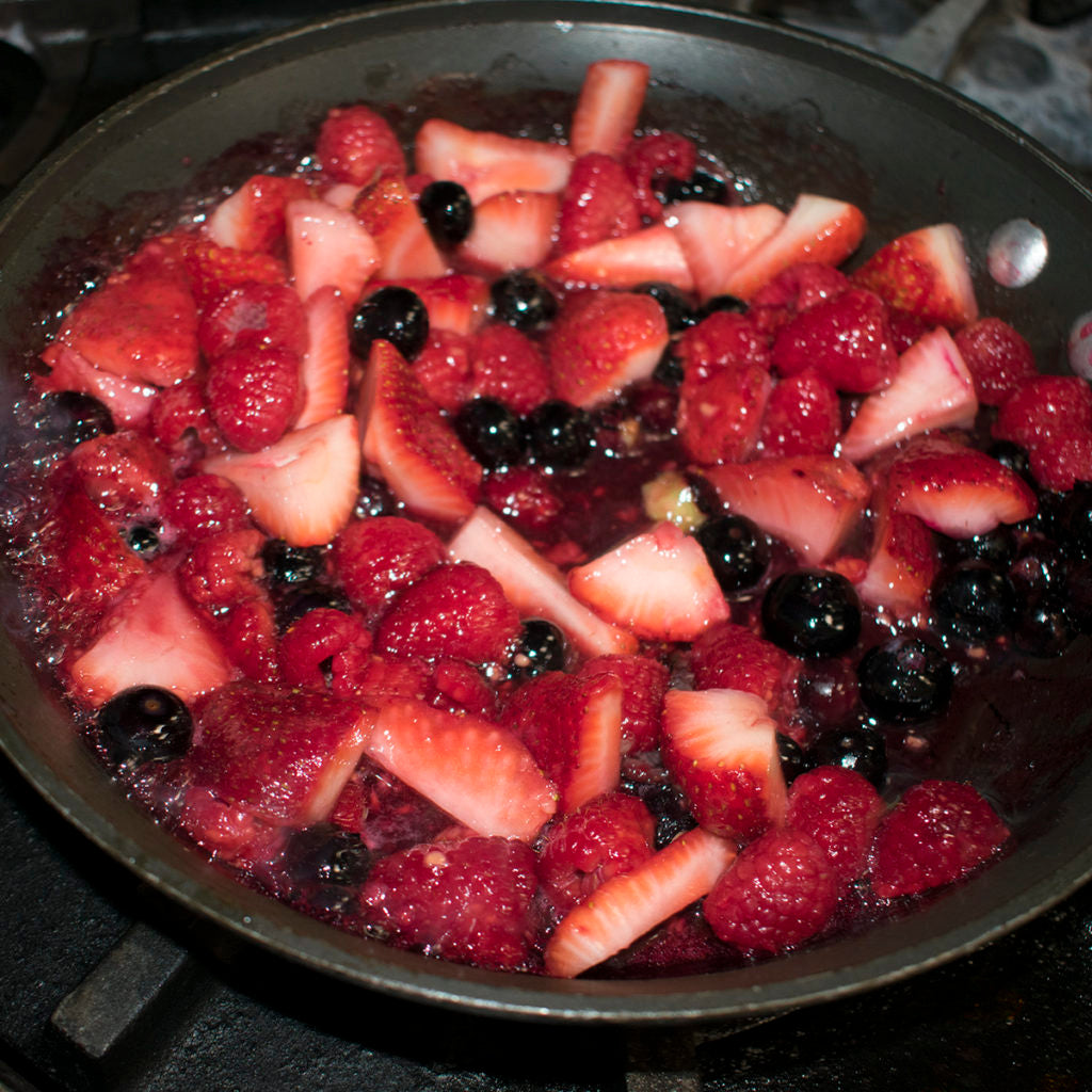 Heat the berries, honey, and water in a saucepan