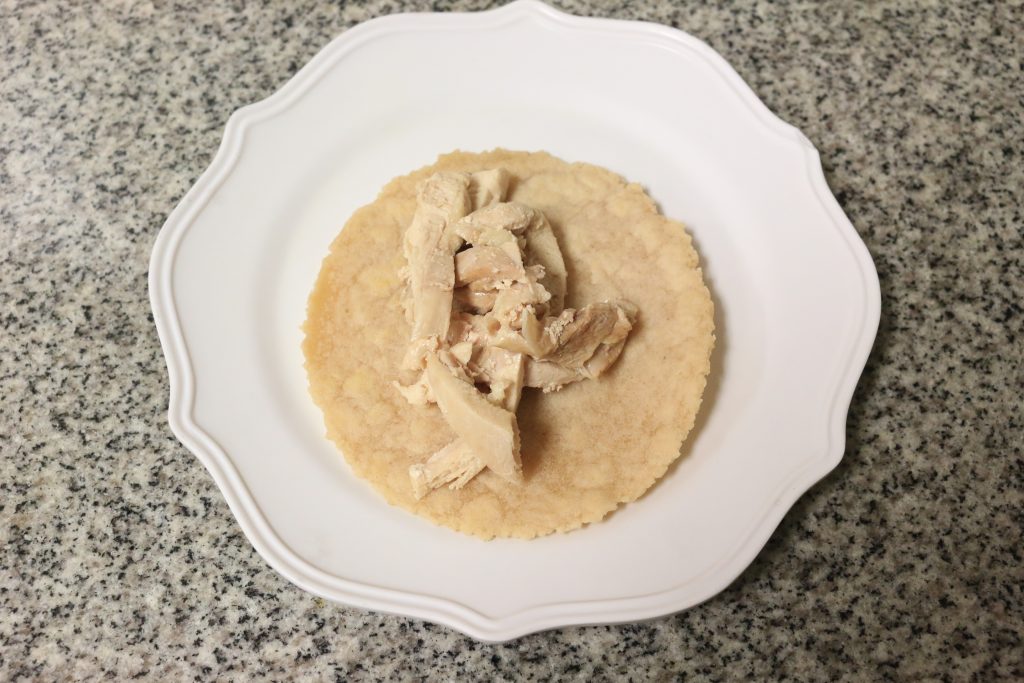 Split chicken meat amongst 4 tortillas