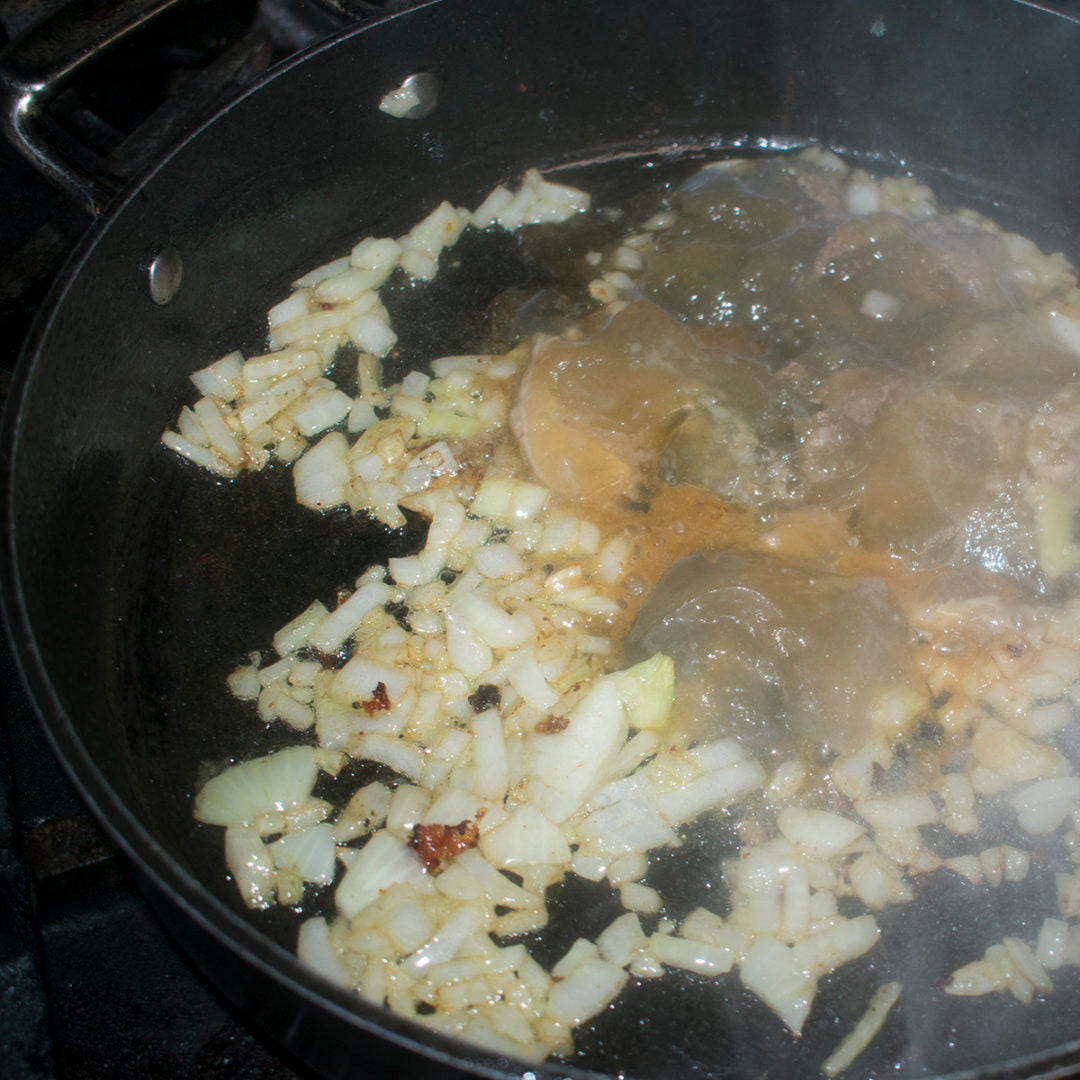 Add the onion and garlic to the pan and fry until onion is translucent