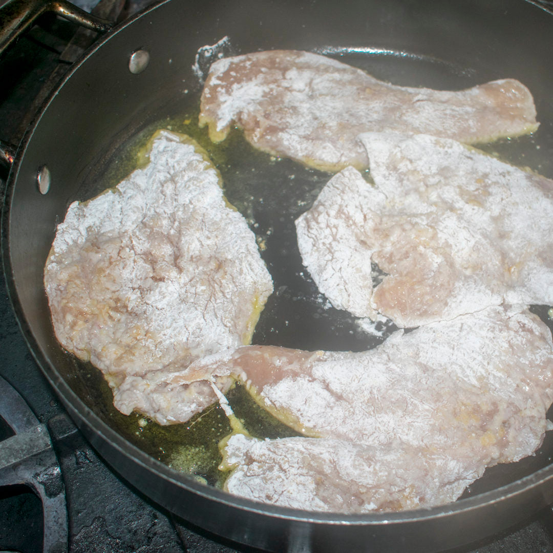 Add the flour to a shallow bowl and dredge each breast in the flour