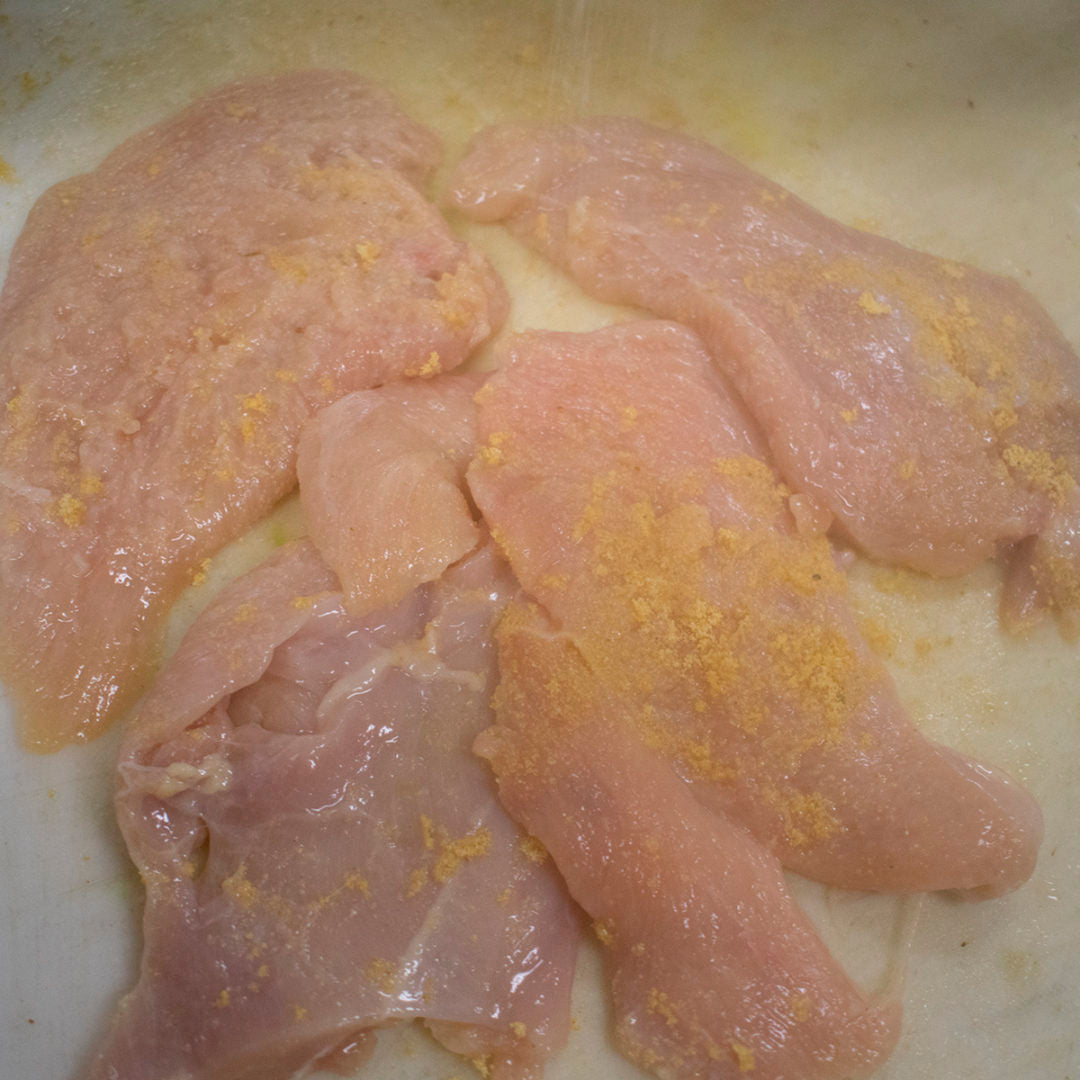 Season chicken with garlic powder and salt