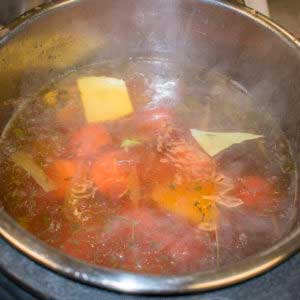 Keeping the cooking liquid, add potatoes and carrots to pressure cooker.