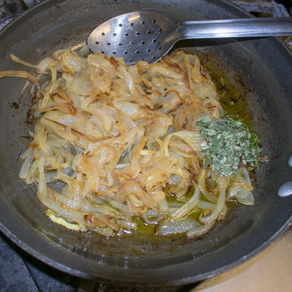 Heat oil in heavy medium saucepan over medium-low heat. Add onions and sage. Cover and cook until onions are deep golden brown, stirring occasionally, about 20 minutes. Remove from heat and let cool.