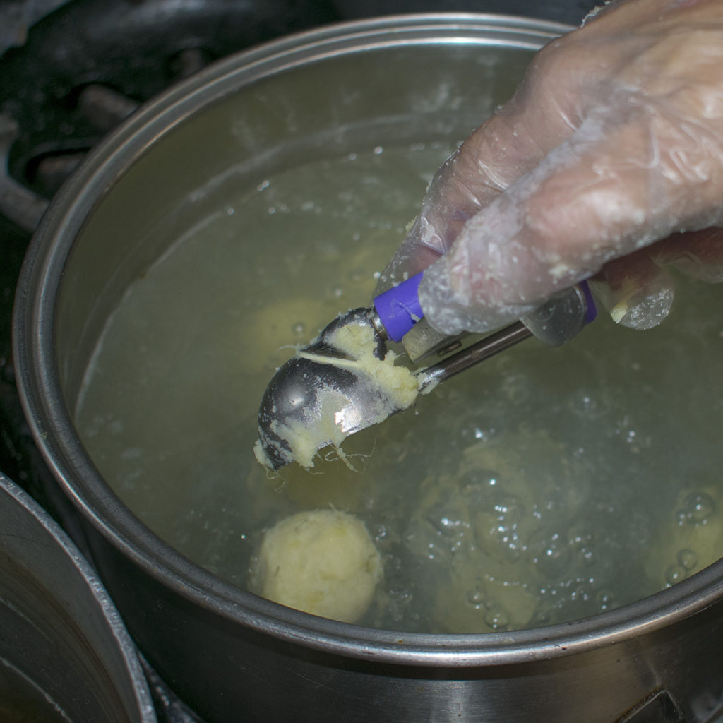 Using a small scoop, make balls of the potato mixture and drop into the boiling water