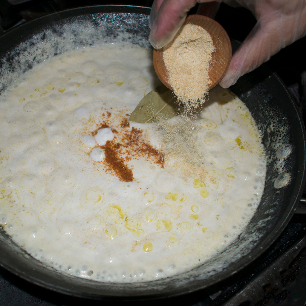 Once all the milk is added, return the heat to medium and add the bay leaf