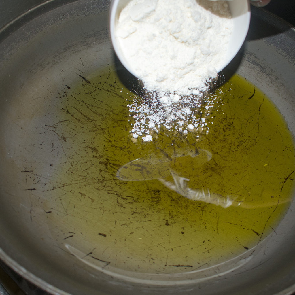 Heat the olive oil in a small pot over medium heat, slowly whisk in the flour