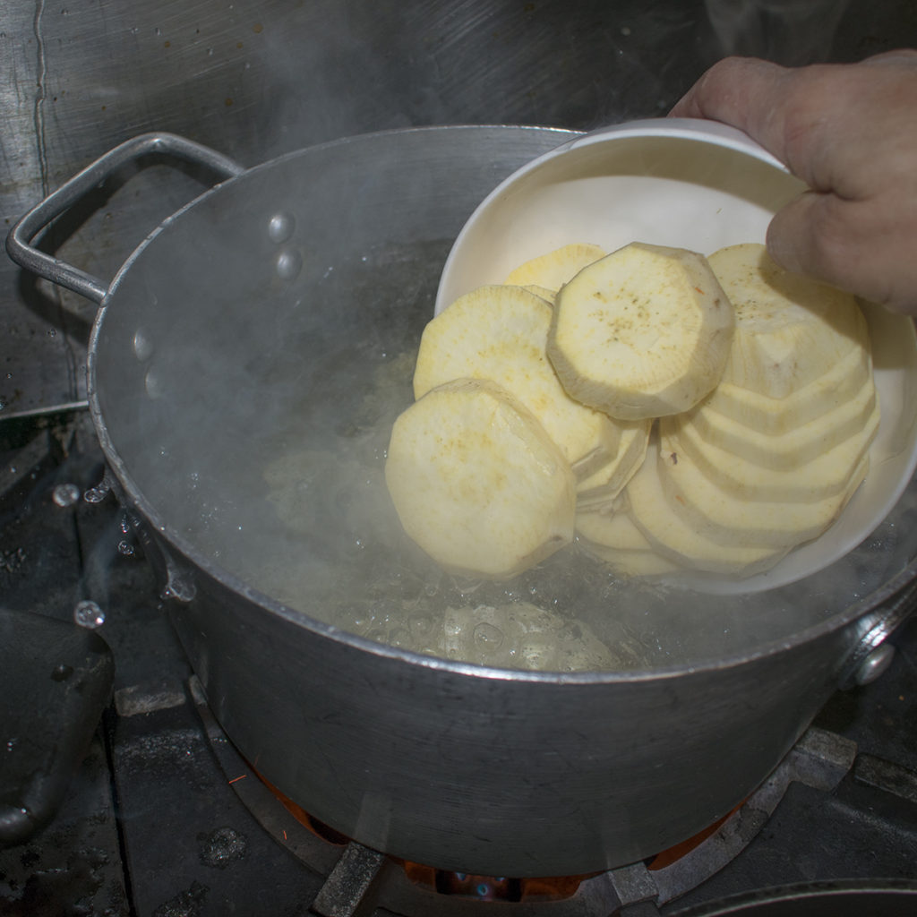 Peel and slice the potatoes into 1/4" rounds and boil them in salted water for 5-8 minutes