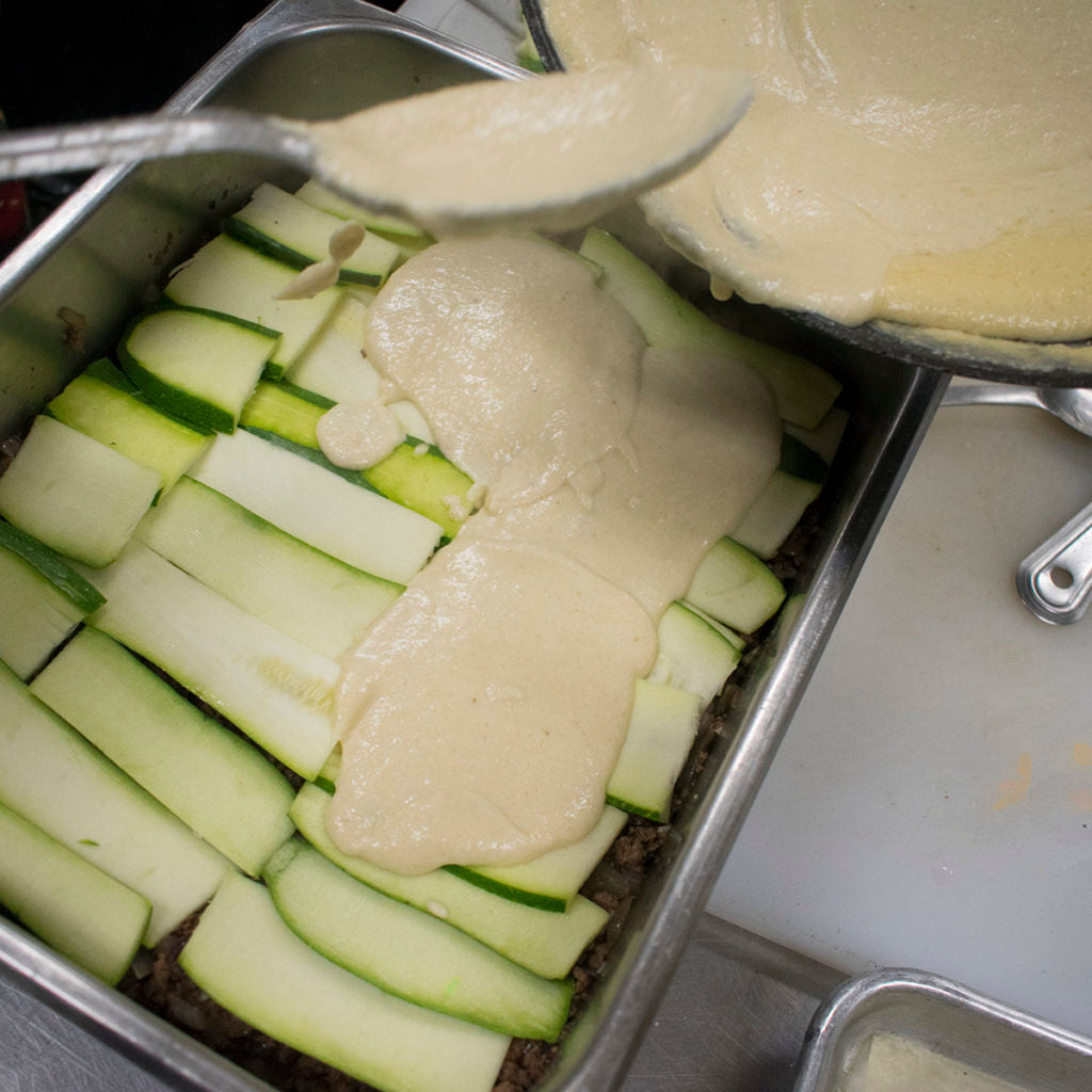 Layer the zucchini slices on top of the meat