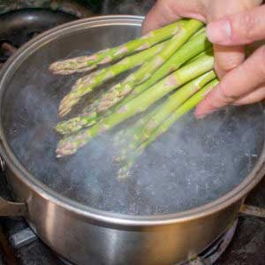  Put asparagus in simmering water and cook until crisp tender