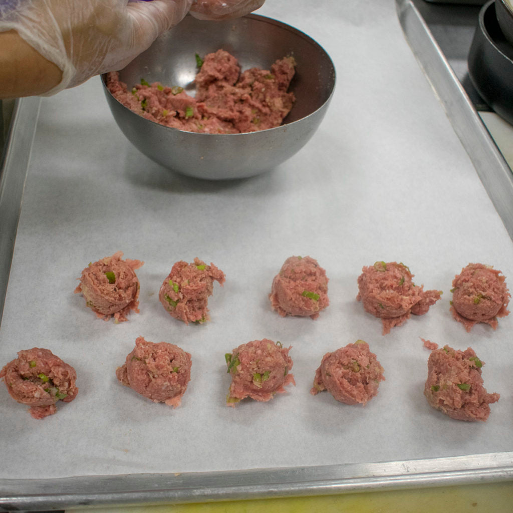 Spoon out 1-inch of meat mixture with a cookie scoop (or tablespoon), shape into balls and place onto 2 large baking sheets or trays lined with baking or parchment paper.