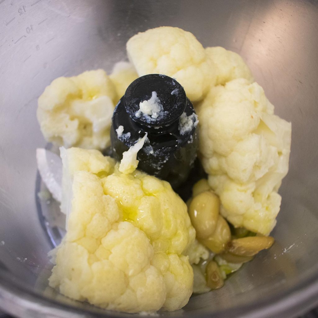 Remove the cloves and oil they were simmered in and place in a food processor with the cauliflower, lemon juice, and sea salt.