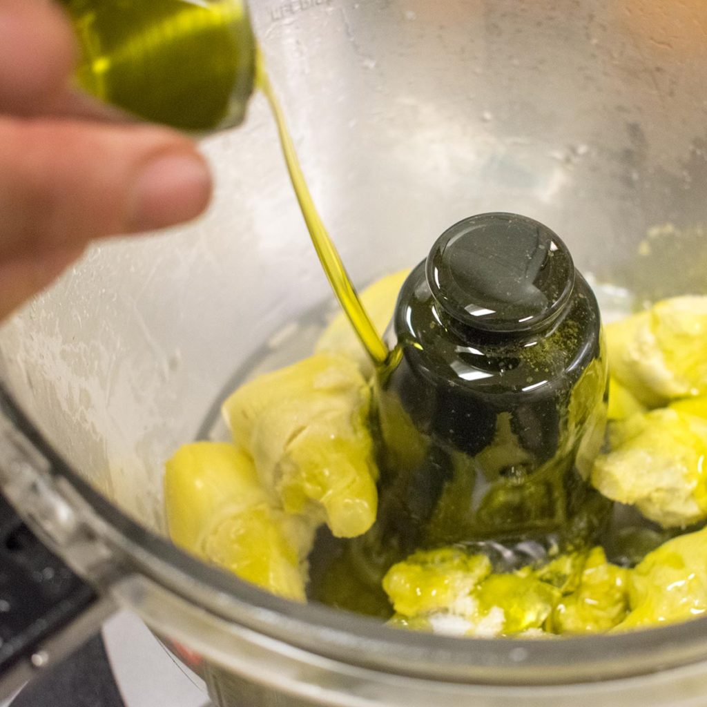 Add the oil and lemon juice to the food processor