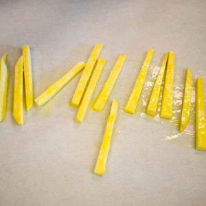 Toss with olive oil and lay the frites out on a parchment lined sheet tray