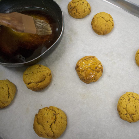 Mix together melted coconut oil and maple syrup for glaze and brush over baked biscuits