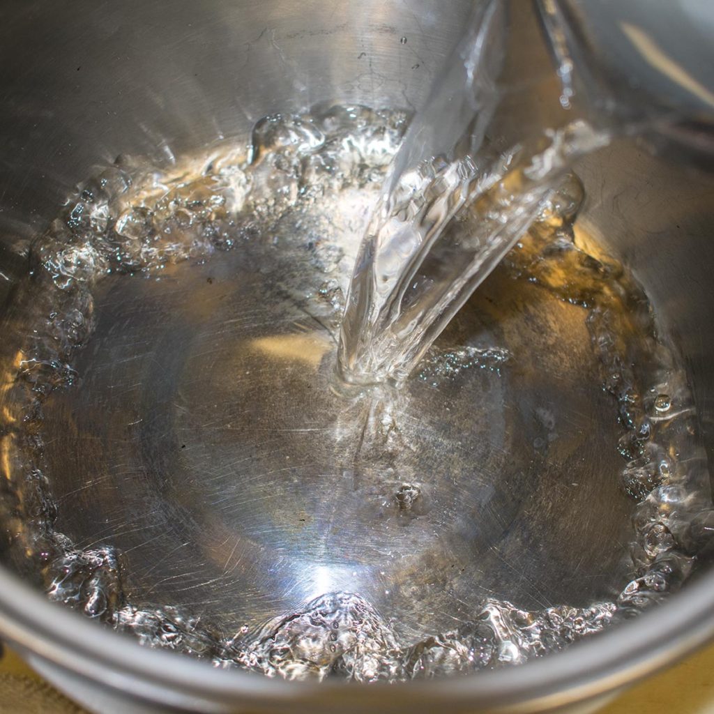 In a pot, combine vinegar, water and salt