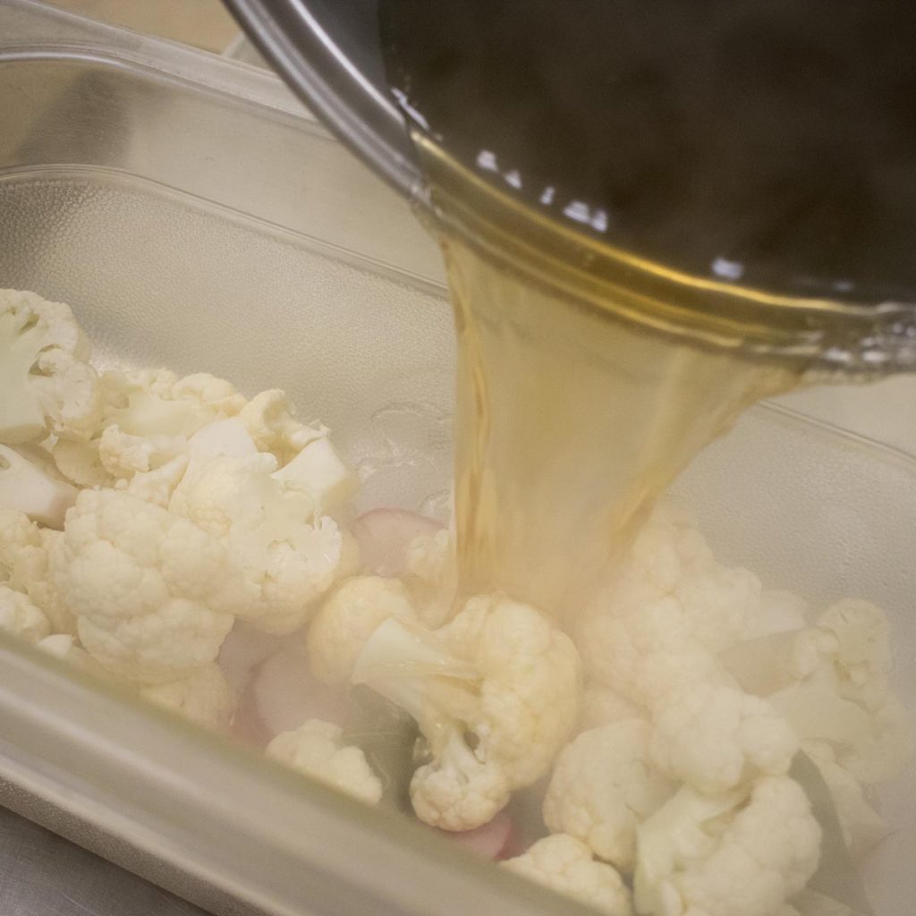 Pour vinegar mixture over vegetables