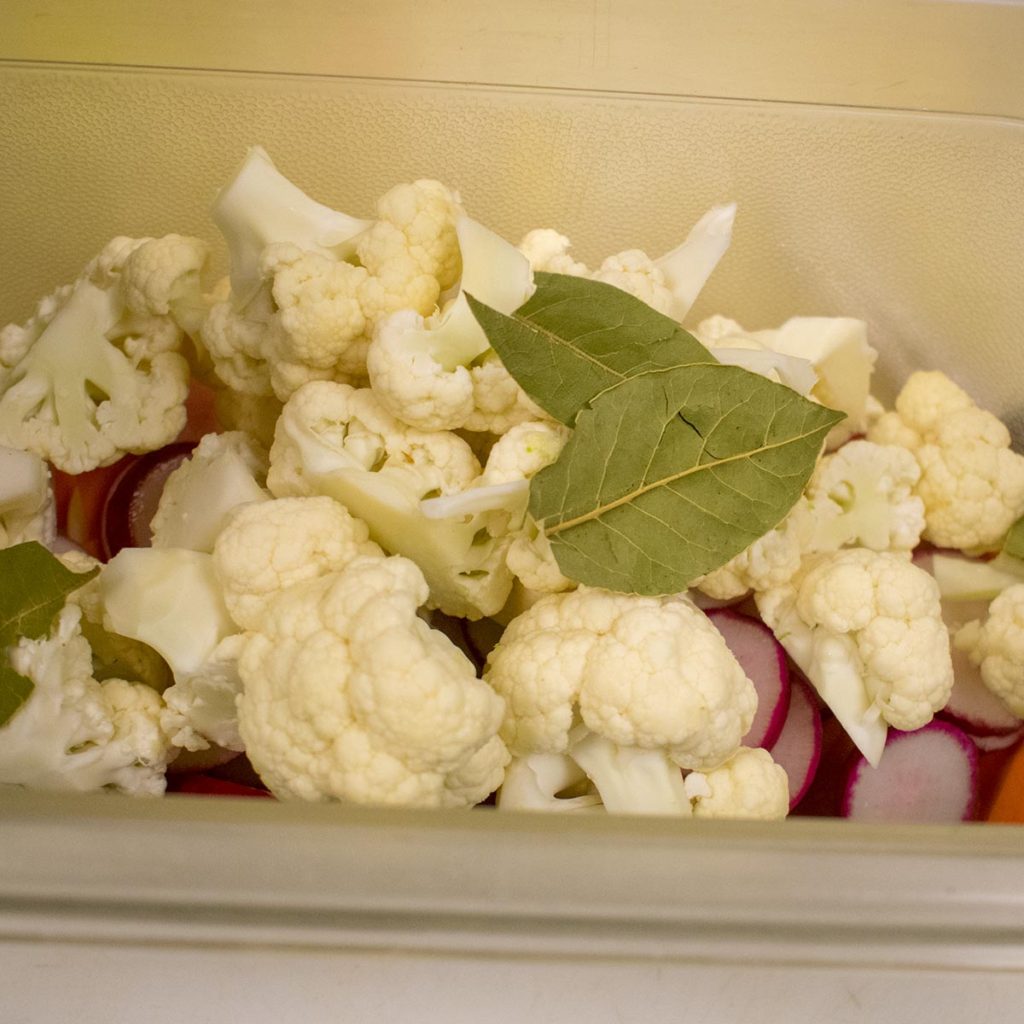 Put cauliflower and bay leaves in