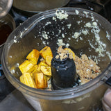 Put plantains in a processor bowl, add garlic, add pork rinds and pulse until well combined