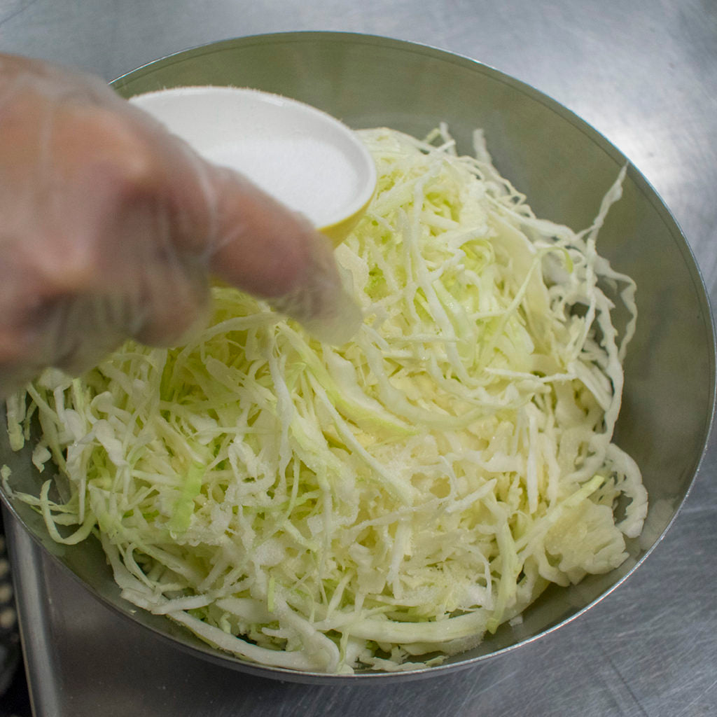 Transfer the cabbage to a large mixing bowl and sprinkle the salt over top