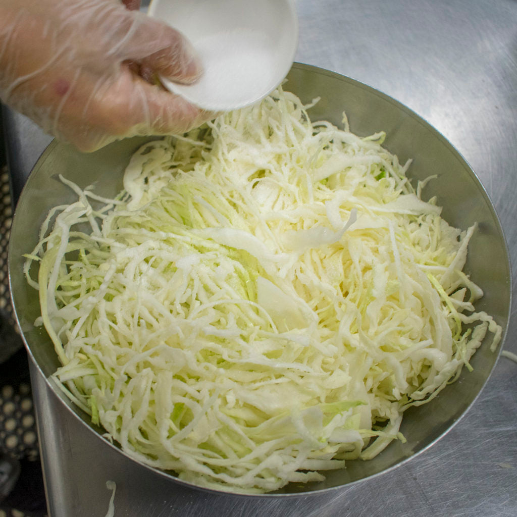 Slice cabbage into very thin ribbons and add salt