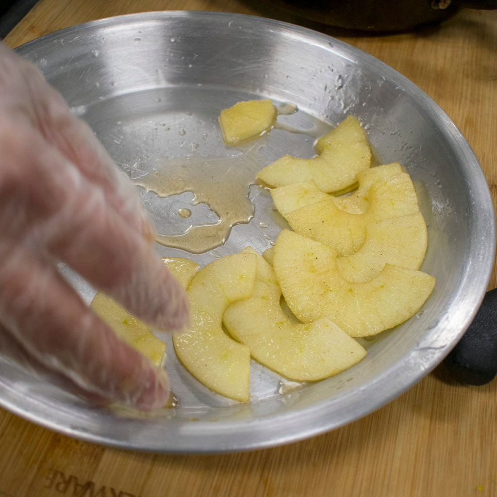 Pour apple slices into parchment-lined cake pan
