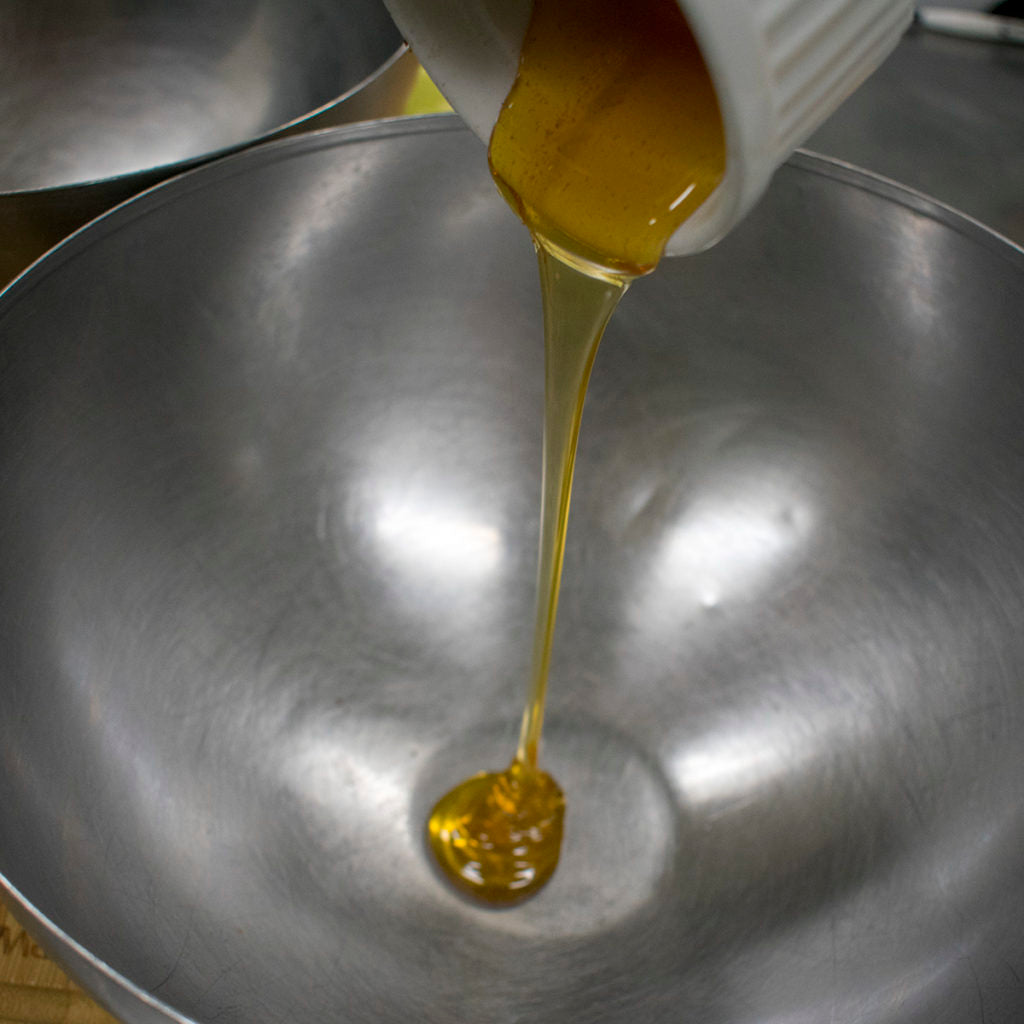 Pour honey into a medium bowl