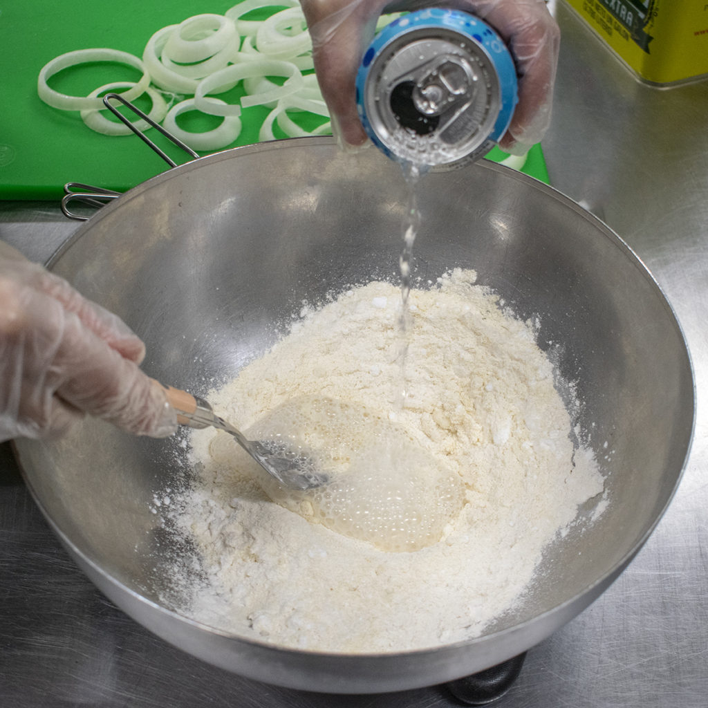 combine flours and salt then whisk seltzer in gradually