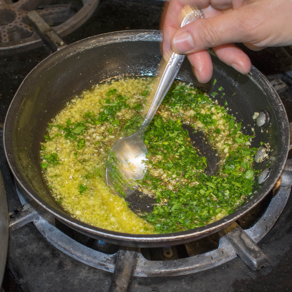 Heat olive oil in a small pan, sweat garlic, add oregano and parsley