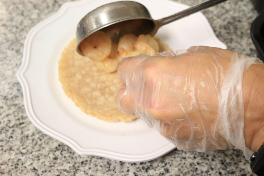 Distribute shrimp amongst the six tortillas