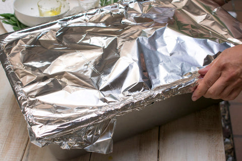 Pour a few inches of water into the bottom of the roasting pan and cover with foil