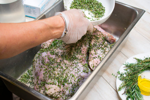Place turkey in deep roasting pan, rub all over with olive oil, season with salt and rub with herb mixture until evenly coated