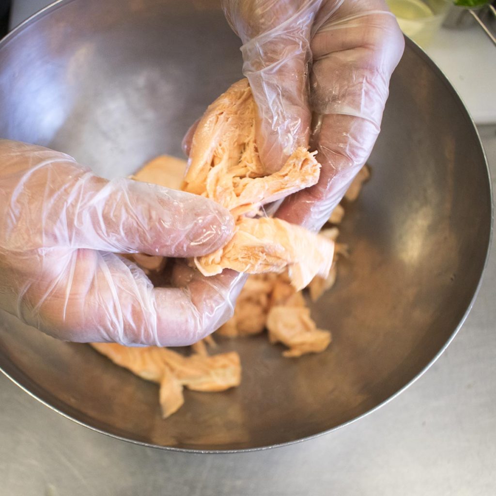 Place salmon in a medium bowl and gently break into small chunks with a fork