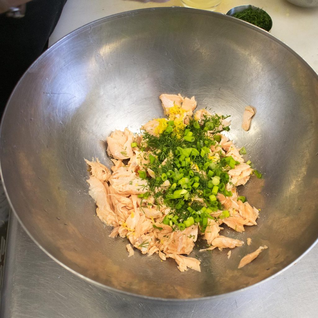 Add lemon zest and juice, coconut cream, dill, scallions, and salt and toss together until evenly mixed