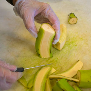 Cut the peels off the green plantains