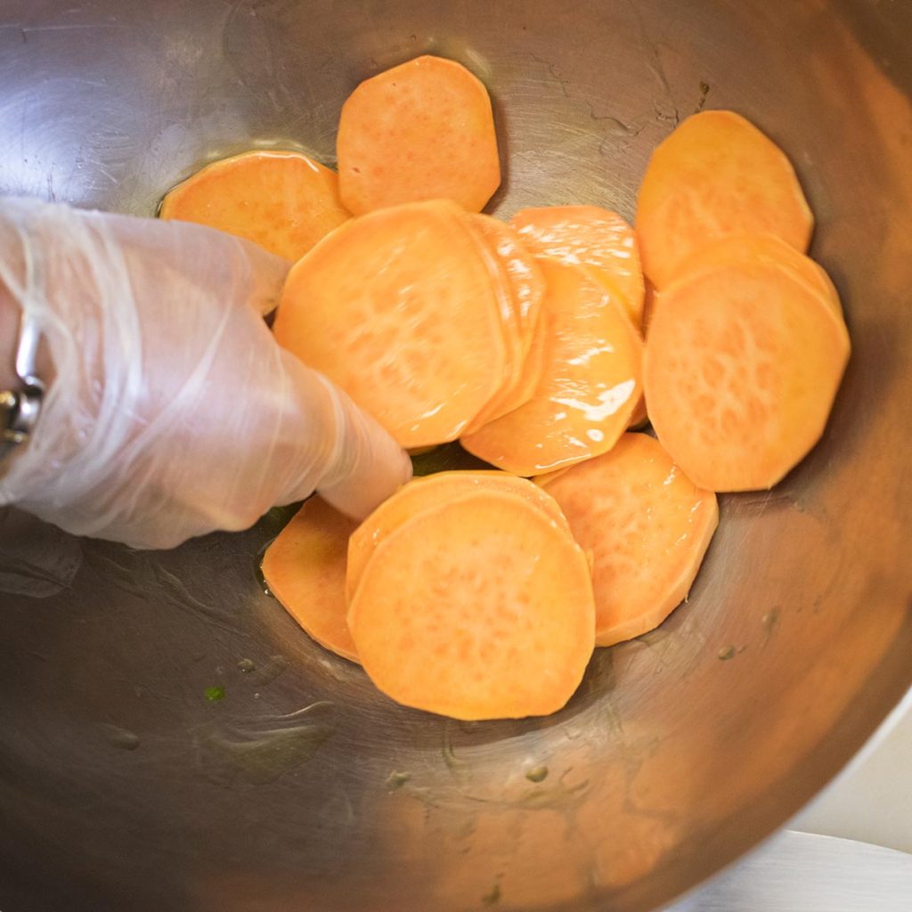 toss sweet potato chips in olive oil and spread onto a parchment lined sheet tray and bake 20 minutes until golden brown and crisp