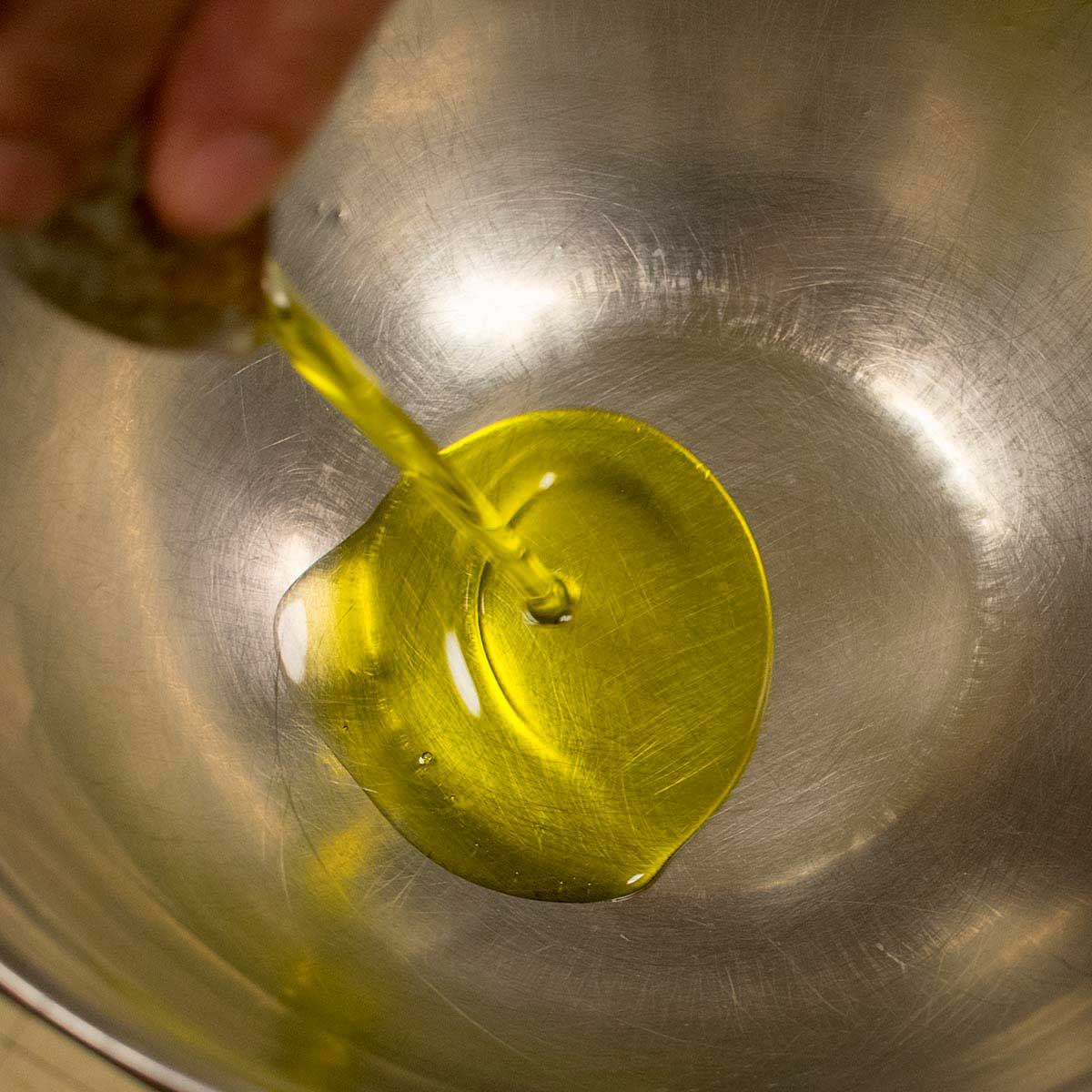 pour olive oil into mixing bowl