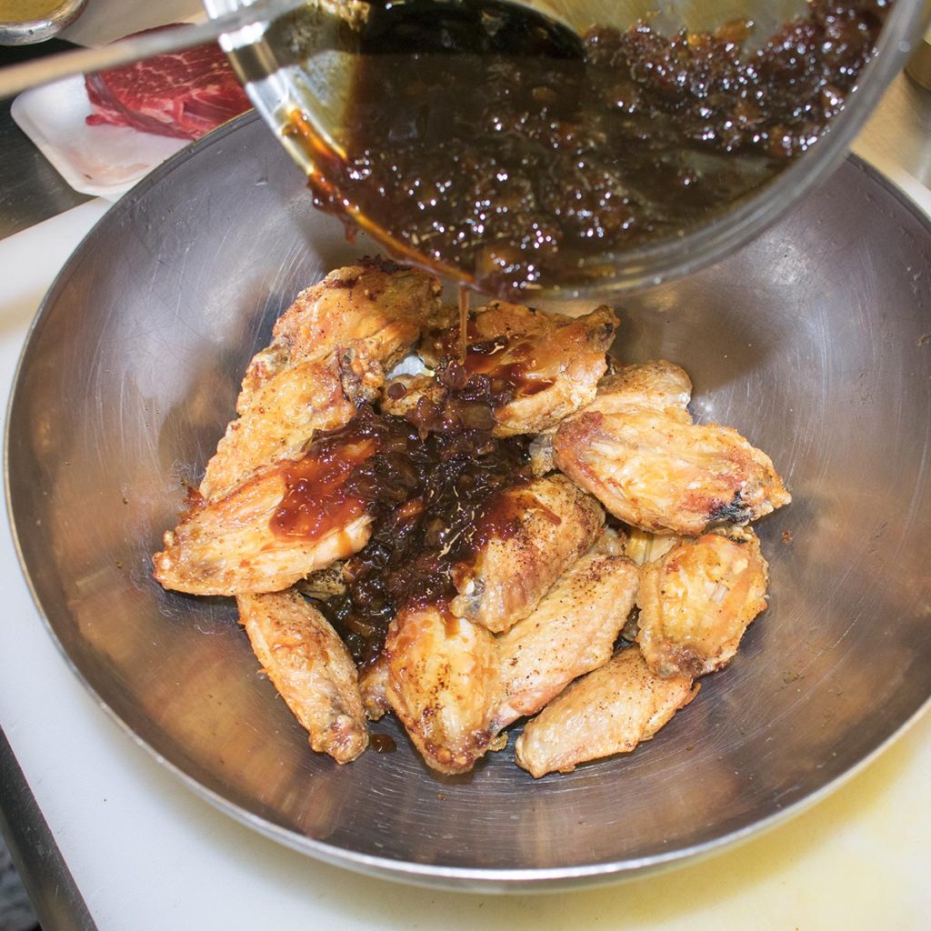 Place cooked wings in a large bowl, add the sauce.