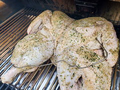 raw turkey on grill with spices