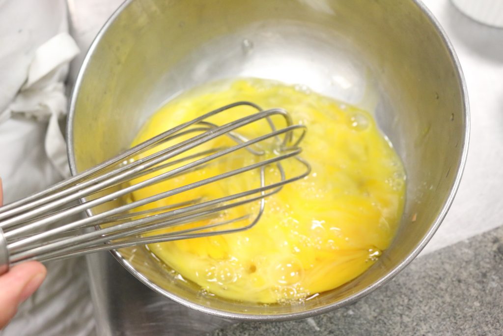 Mix eggs, milk, nutritional yeast, garlic, salt and pepper