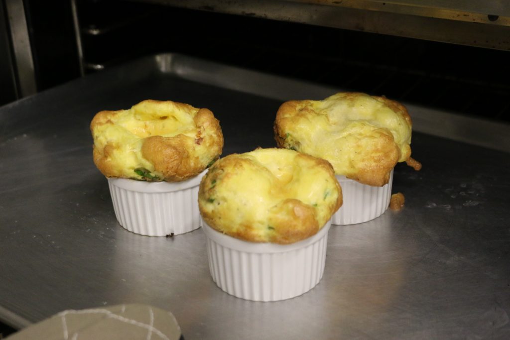 Place ramekins on cookie sheet and bake at 375 degrees for 30 minutes until high and puffy