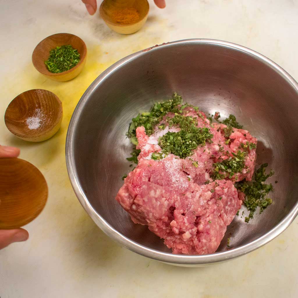 add spices to ground pork