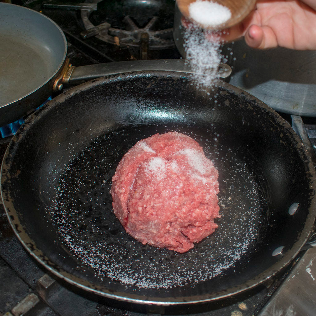 add aip ground beef to skillet and season with salt