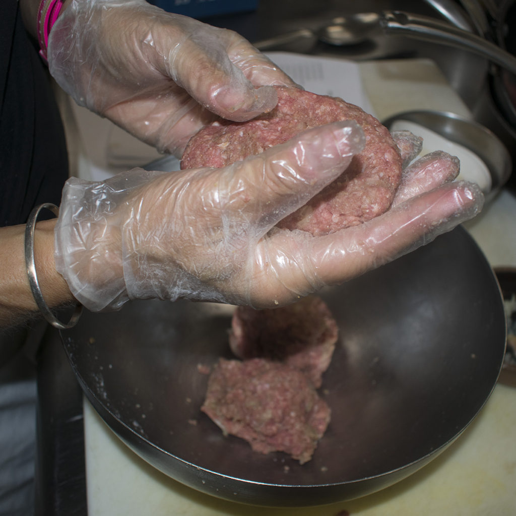 Divide the beef mixture into four equal size portions and form into patties about 1/2 inch thick