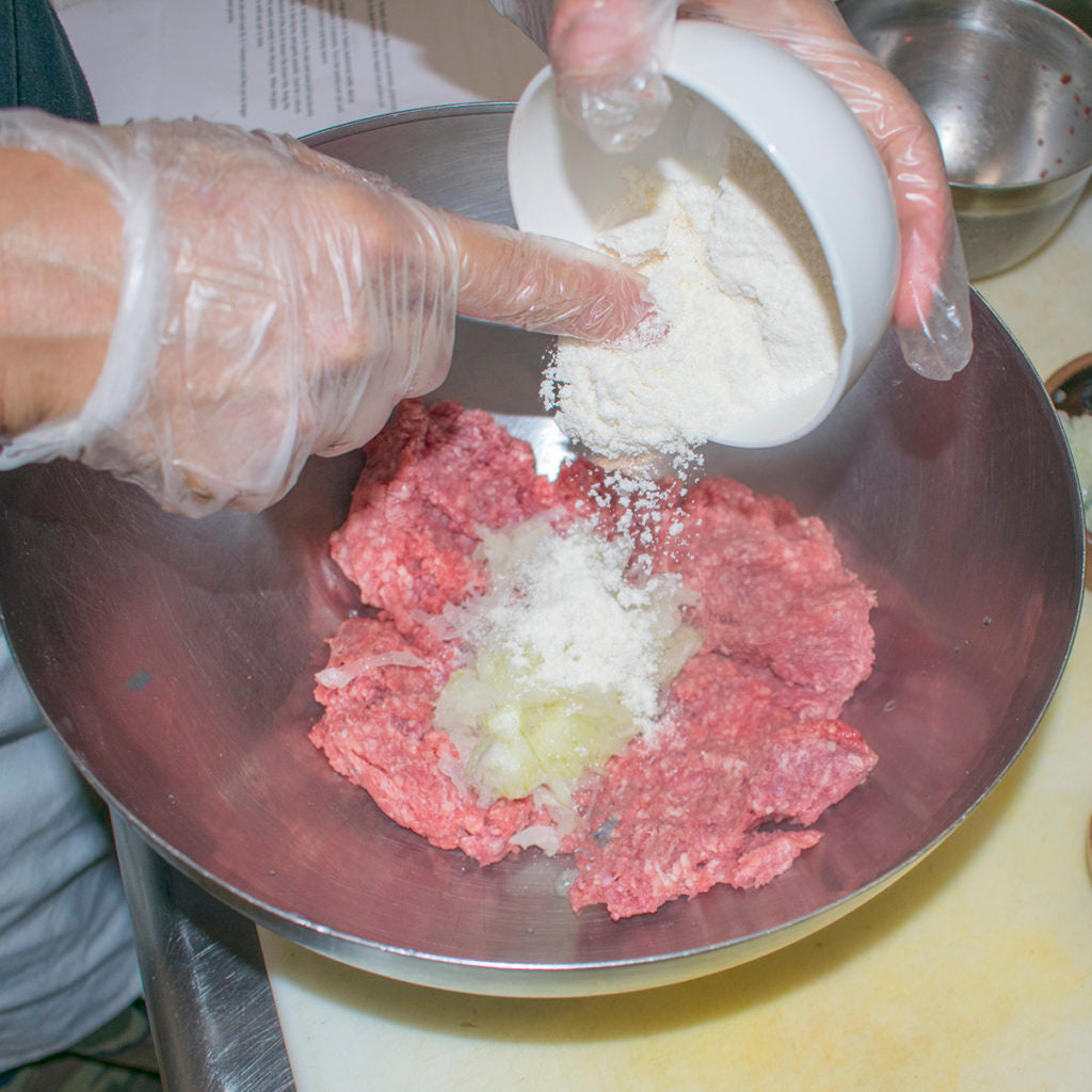 In a large bowl, use your hands to blend together the beef and coconut flour
