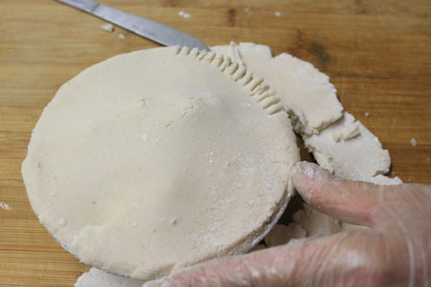 Roll out another dough circle and place it on top of the fruit filled pie shell.
