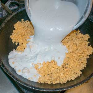 In a sauté pan, add the plantain grains and 3 cups of coconut milk.
